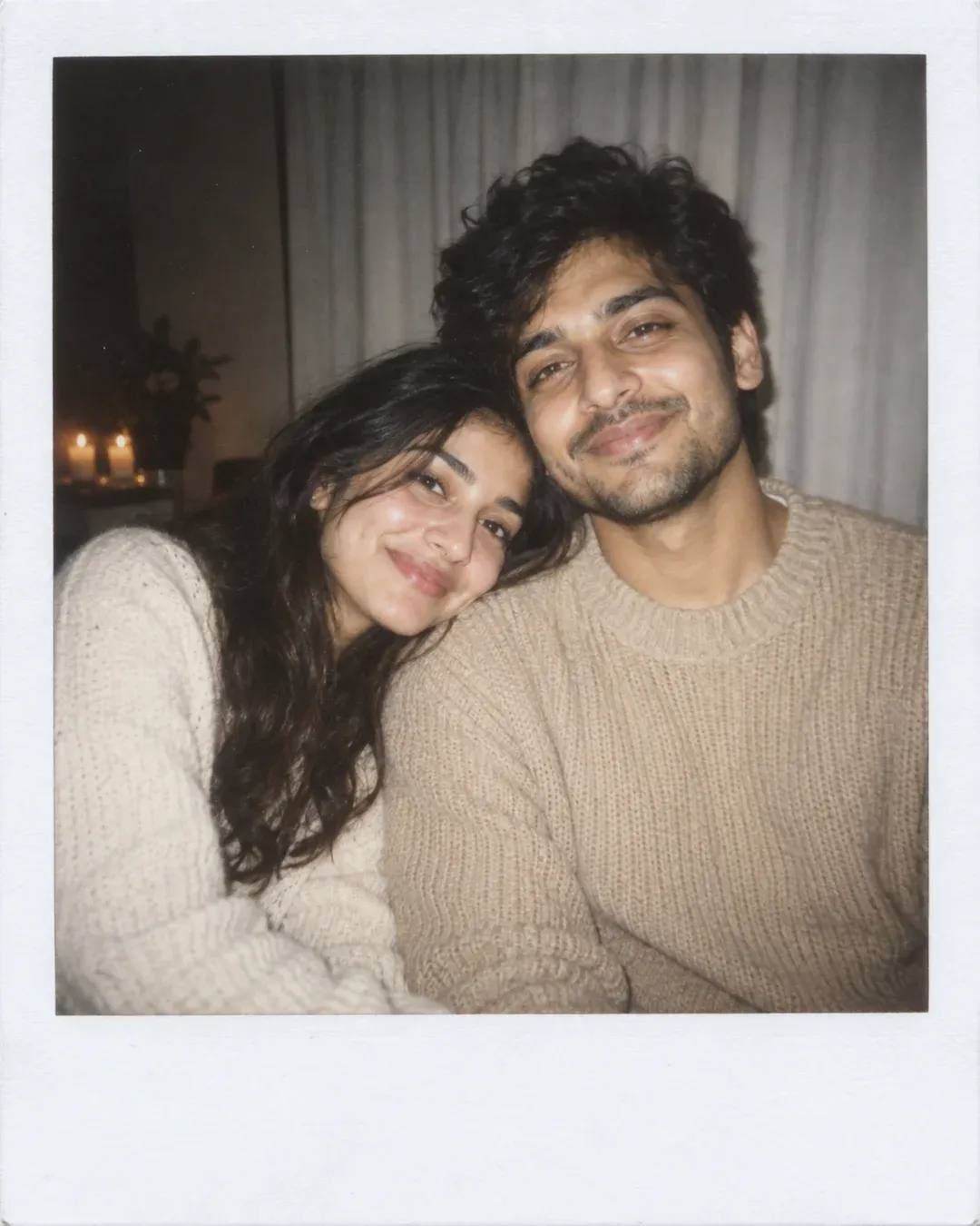 Example result: A couple poses close together in front of a white curtain, lit by direct flash, framed as a polaroid print.